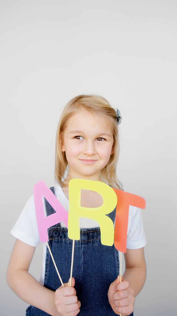 girl holding her artwork